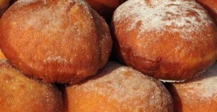 classic fried donuts dusted with powdered sugar