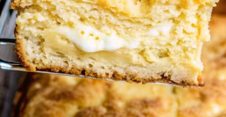 "A slice of cream cheese-filled coffee cake with golden cinnamon streusel topping"
