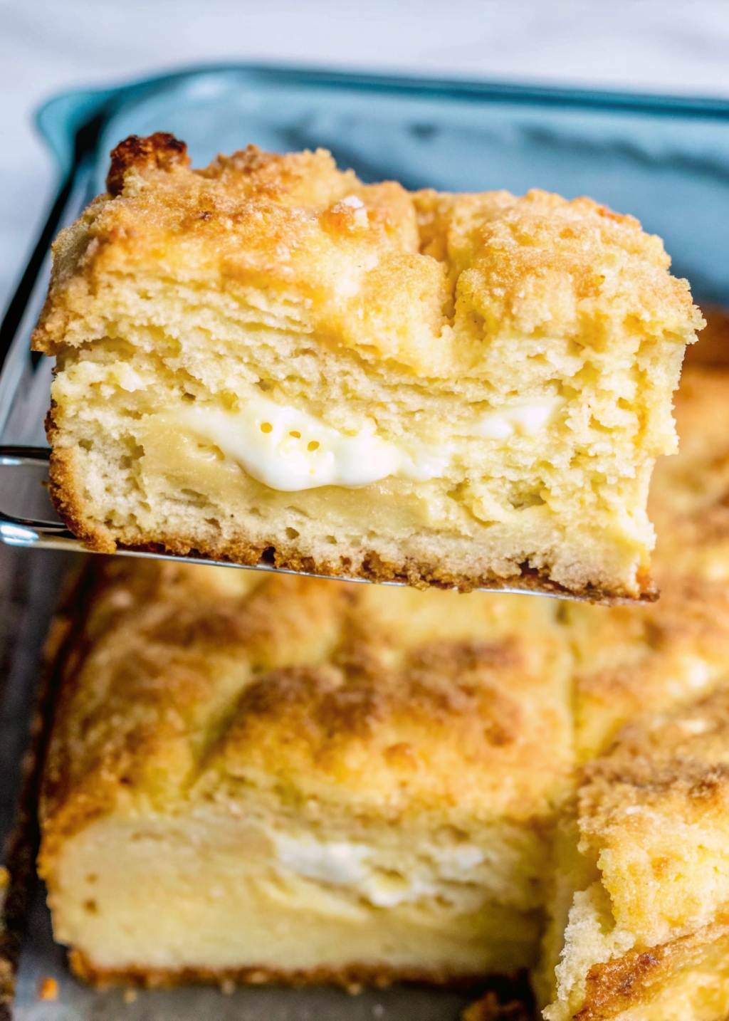 "A slice of cream cheese-filled coffee cake with golden cinnamon streusel topping"