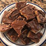 "Easy chocolate toffee bark broken into pieces on a parchment-lined baking sheet"