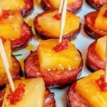 Slow Cooker Apple Kielbasa Bites served in a slow cooker with caramelized glaze