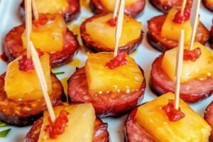 Slow Cooker Apple Kielbasa Bites served in a slow cooker with caramelized glaze