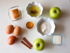 Ingredients for Apple Cinnamon Cake including flour, apples, and cinnamon