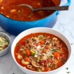 “Italian Sausage Soup with pasta, beans, and vegetables in a bowl”