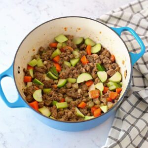 “Italian Sausage Soup with pasta, beans, and vegetables in a bowl”