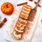 Keto Pumpkin Roll with cream cheese filling on a white plate